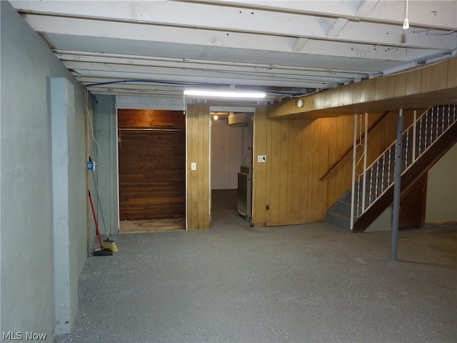 basement featuring wood walls