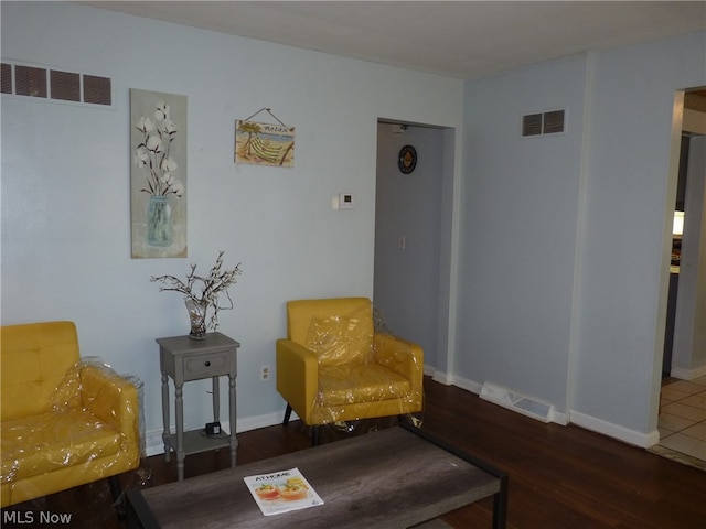 sitting room with wood-type flooring