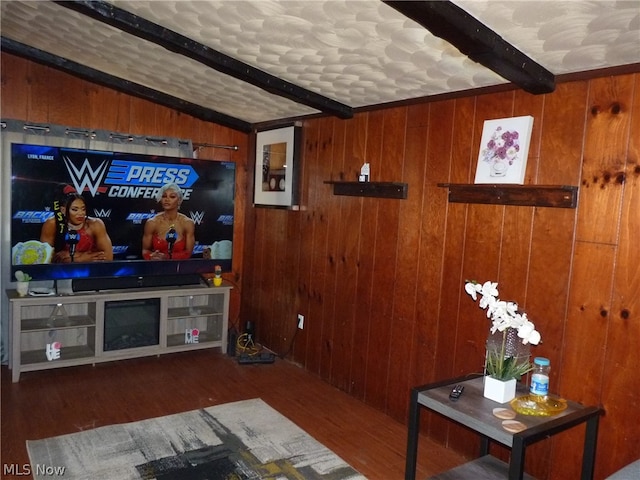 living room featuring beamed ceiling and dark hardwood / wood-style flooring