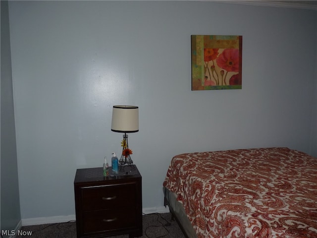 bedroom with dark colored carpet