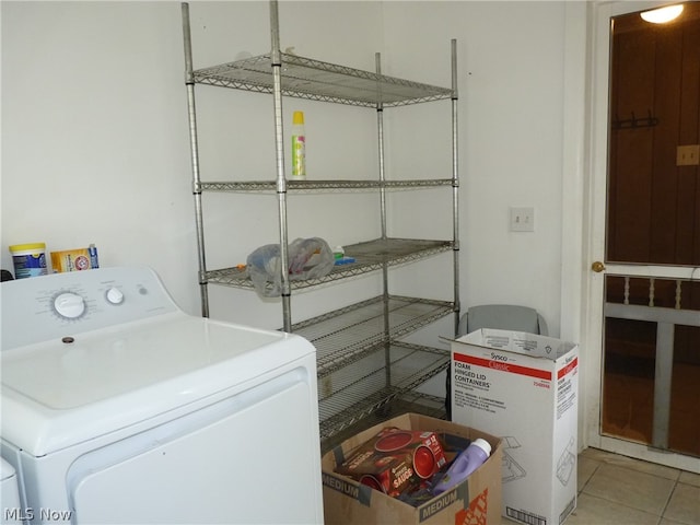 laundry area featuring tile patterned floors and washer and clothes dryer