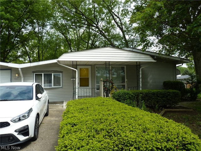 view of front of house featuring a porch and a garage