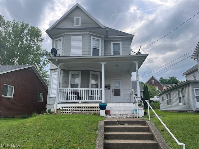 view of front of property with a porch and a front lawn