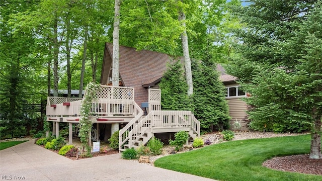 view of front of property featuring a front lawn and a wooden deck