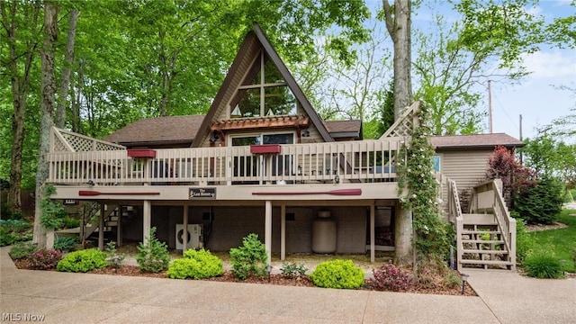 rear view of property with a wooden deck