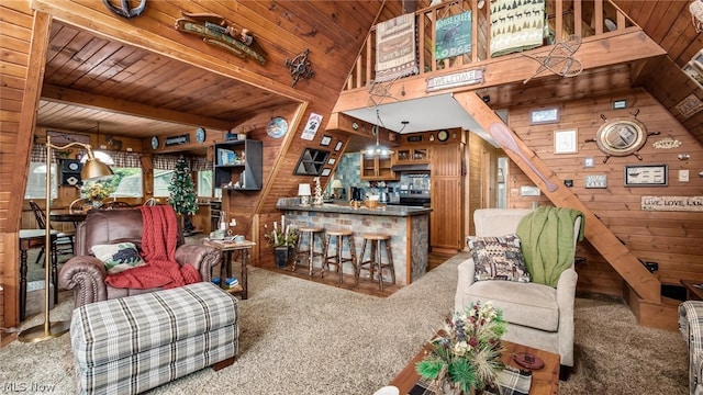 living room with wooden ceiling, wood walls, carpet, and beam ceiling