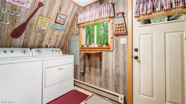 laundry room featuring wood walls, independent washer and dryer, and baseboard heating