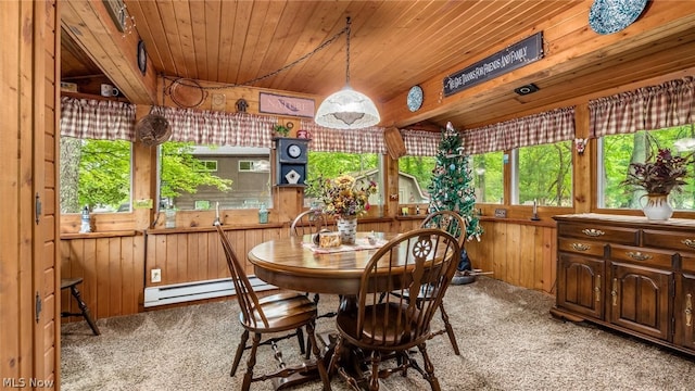 dining room featuring carpet flooring, a baseboard radiator, and wood ceiling