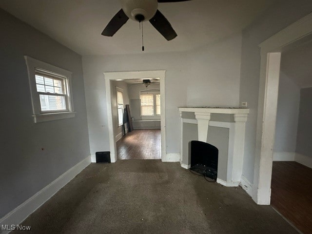 unfurnished living room with plenty of natural light and dark hardwood / wood-style flooring