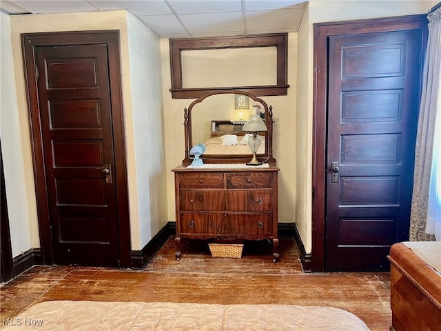 foyer entrance featuring a paneled ceiling and hardwood / wood-style flooring