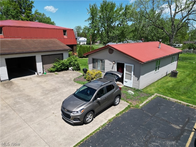 view of front of home with a garage, a front yard, and an outdoor structure