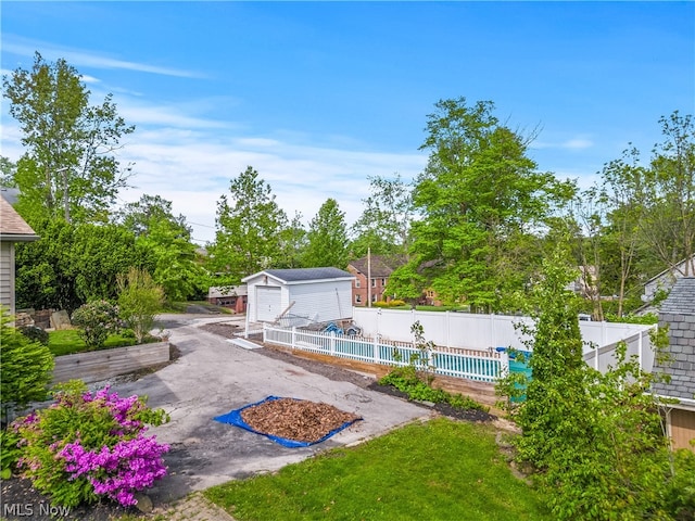 view of yard with a fenced in pool and an outdoor structure