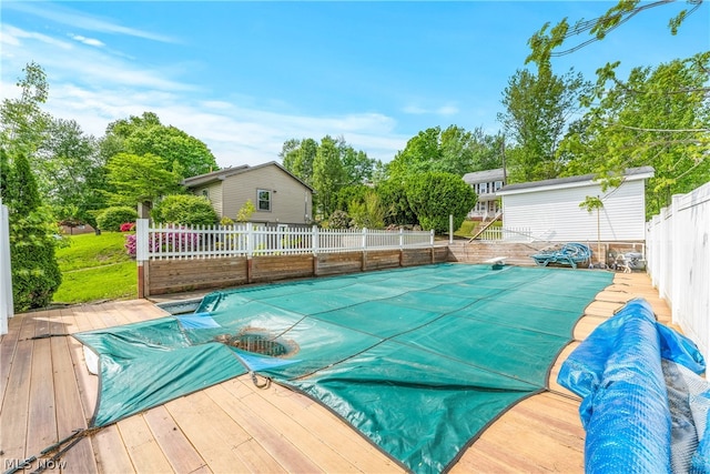 view of swimming pool with a deck