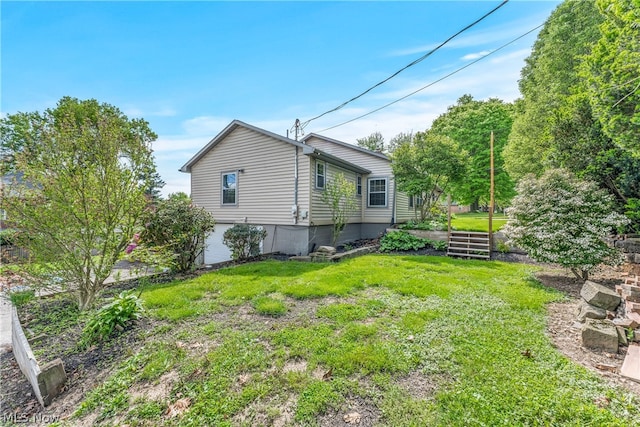 view of side of home featuring a lawn