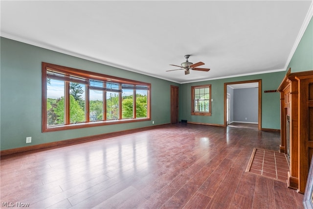 unfurnished room featuring dark hardwood / wood-style flooring, ceiling fan, and crown molding