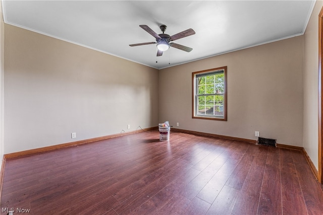 spare room featuring dark hardwood / wood-style flooring, ceiling fan, and crown molding