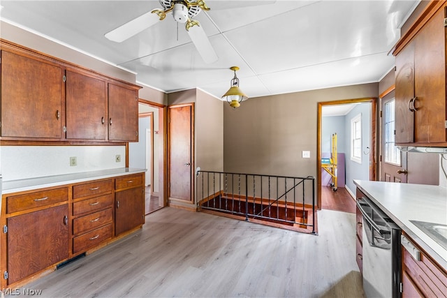 kitchen featuring light wood-type flooring, decorative light fixtures, ceiling fan, and stainless steel dishwasher