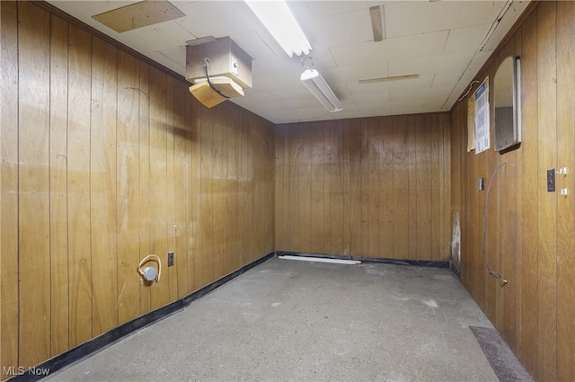 unfurnished room with wood walls