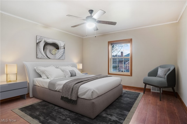 bedroom with ceiling fan, dark hardwood / wood-style floors, and crown molding