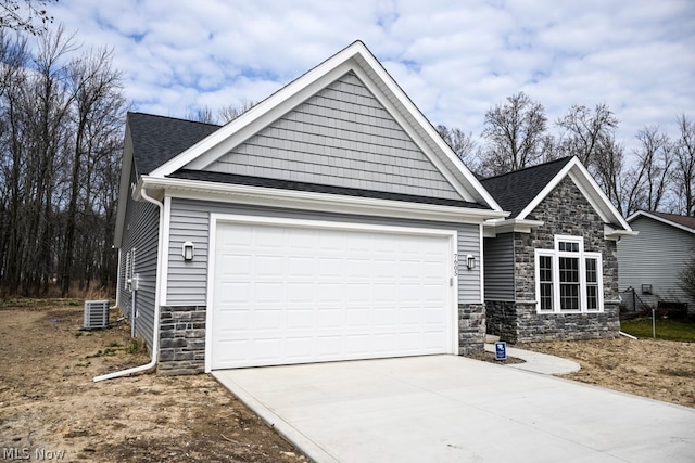 craftsman-style home with a garage and central air condition unit