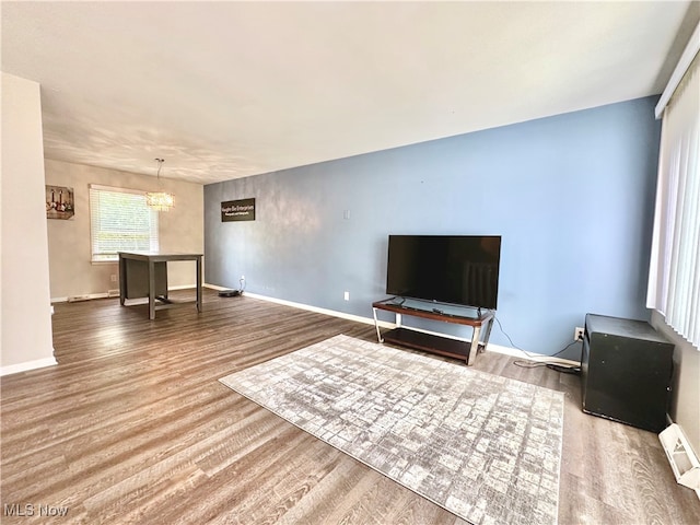 living room with wood-type flooring and a notable chandelier