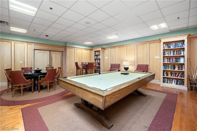 recreation room featuring pool table, a paneled ceiling, and light wood-type flooring