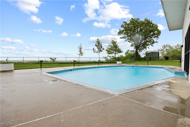 view of swimming pool featuring a yard and a patio