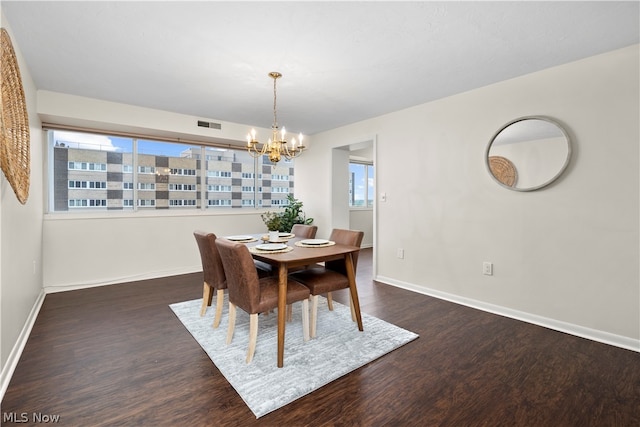 dining room with a chandelier and dark wood-type flooring