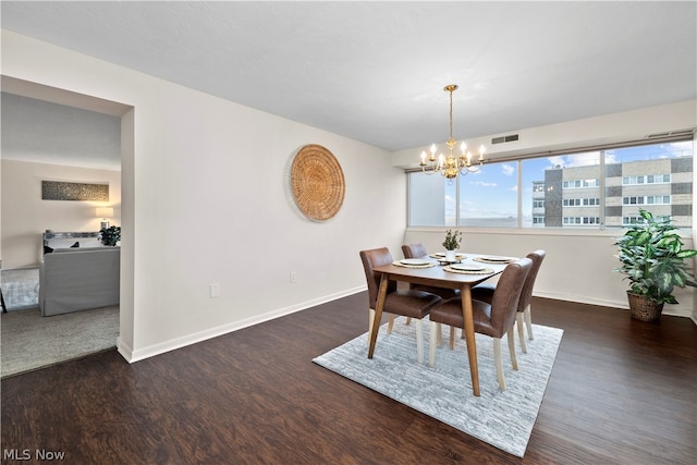 dining room featuring a notable chandelier and dark hardwood / wood-style flooring