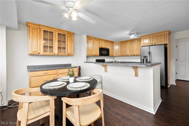 kitchen with stainless steel fridge, ceiling fan, and dark hardwood / wood-style floors