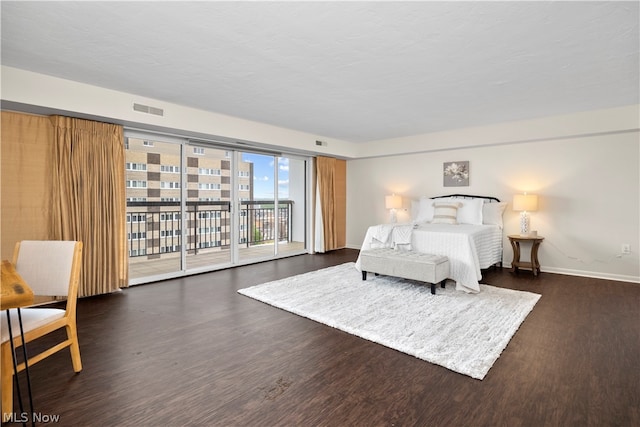 bedroom featuring dark hardwood / wood-style floors and access to outside