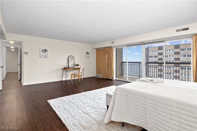 bedroom featuring dark wood-type flooring and access to exterior