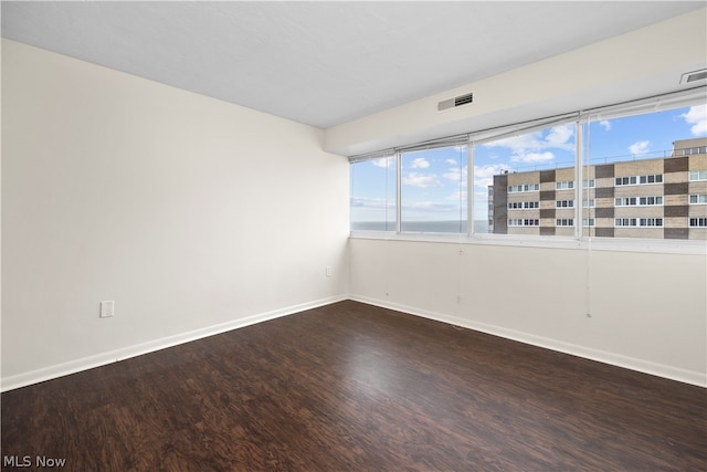 empty room with wood-type flooring