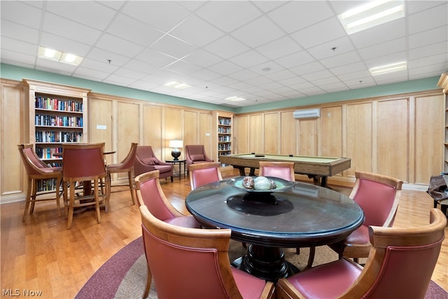 dining room featuring a paneled ceiling, billiards, and light hardwood / wood-style flooring