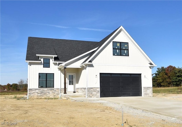 modern inspired farmhouse with a garage