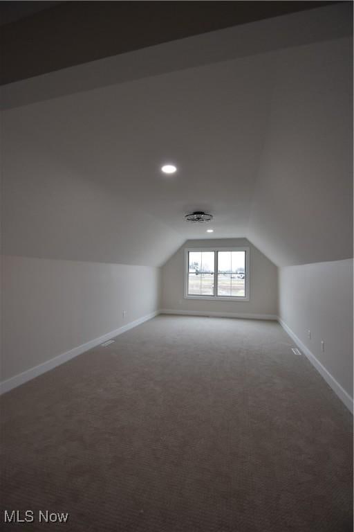 additional living space with lofted ceiling, baseboards, carpet flooring, and recessed lighting