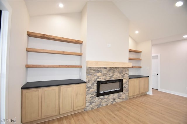 unfurnished living room with light wood-type flooring, baseboards, vaulted ceiling, and recessed lighting