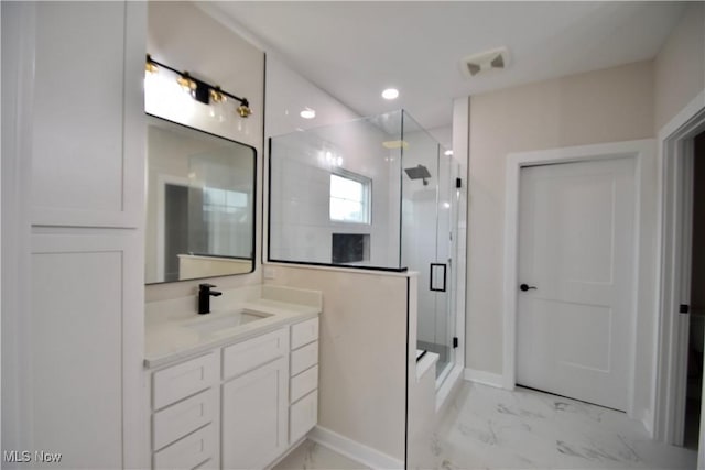 full bathroom featuring marble finish floor, a shower stall, baseboards, and vanity