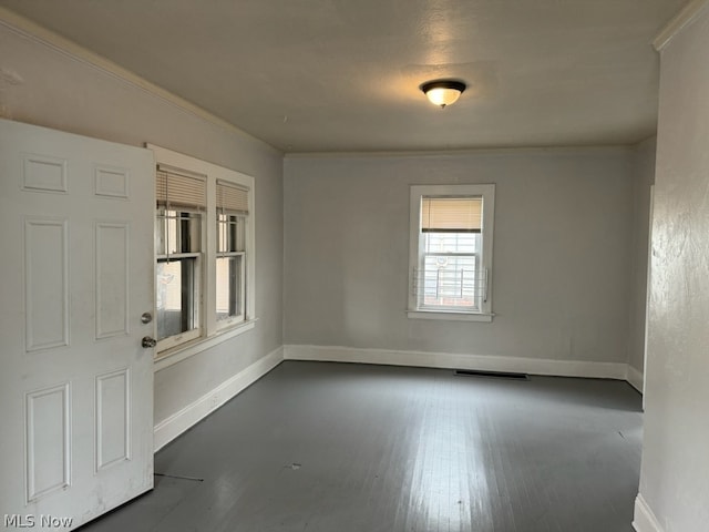 unfurnished room with dark hardwood / wood-style flooring and crown molding