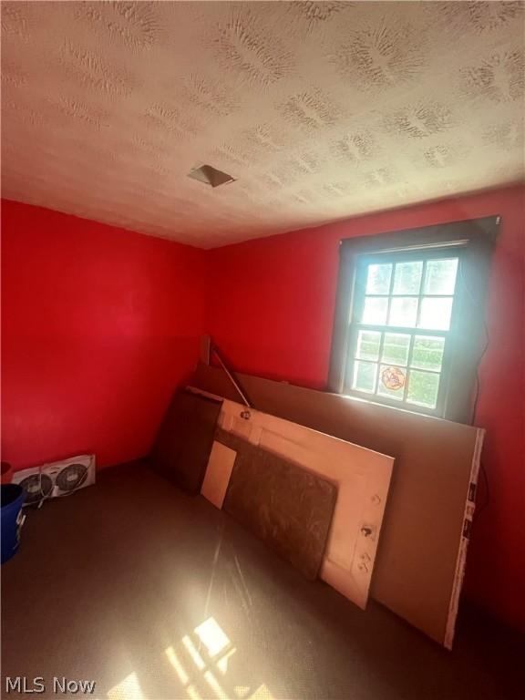 unfurnished bedroom with a textured ceiling