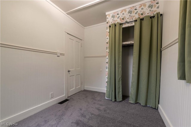 unfurnished bedroom featuring carpet flooring and crown molding