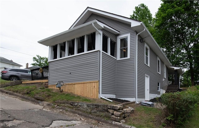 view of side of property featuring a sunroom