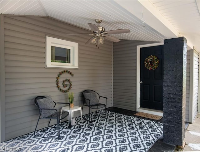 property entrance featuring ceiling fan and a porch