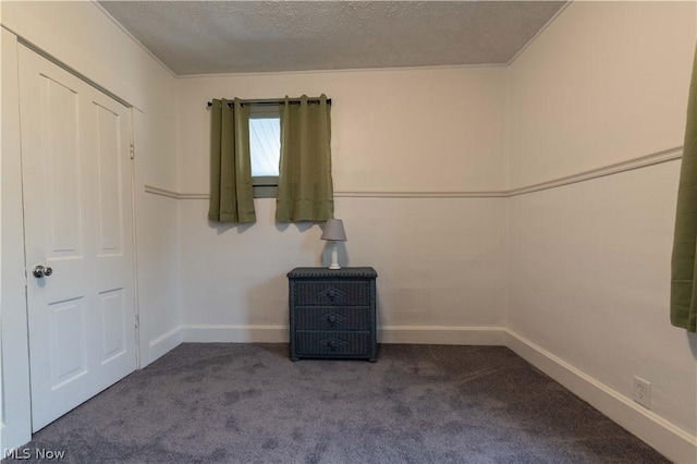 unfurnished bedroom with carpet flooring and a textured ceiling