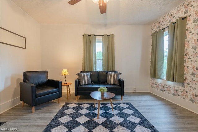 living area featuring a wealth of natural light, hardwood / wood-style floors, ceiling fan, and a textured ceiling