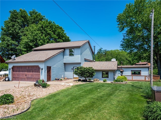 view of front of house with a garage and a front lawn