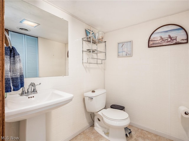 bathroom with sink, tile patterned floors, and toilet