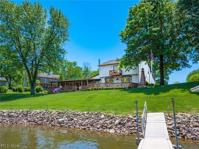 view of dock featuring a water view and a yard