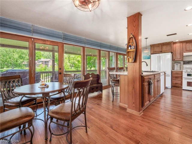 dining room featuring sink and light wood-type flooring