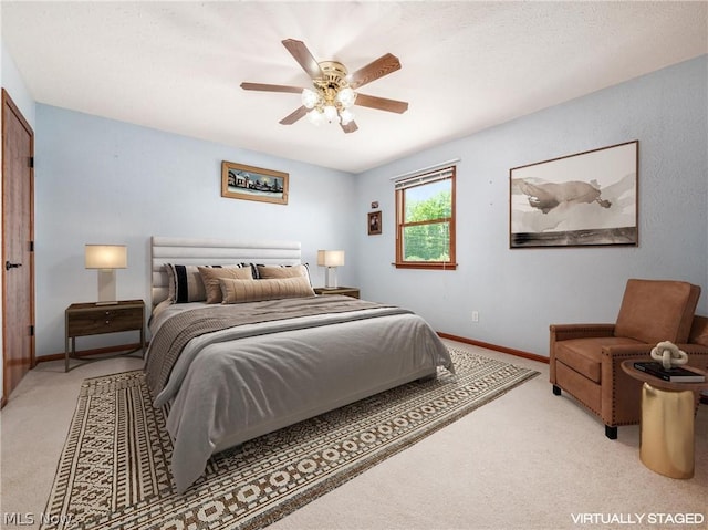 bedroom with ceiling fan and light colored carpet